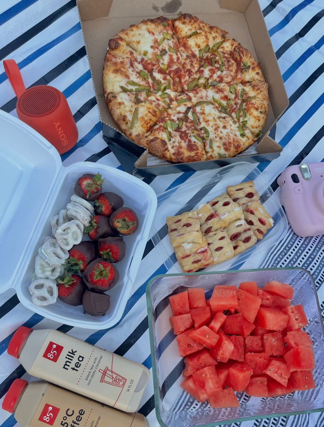 Pizza, chocolate-covered strawberries, pastries, and watermelon